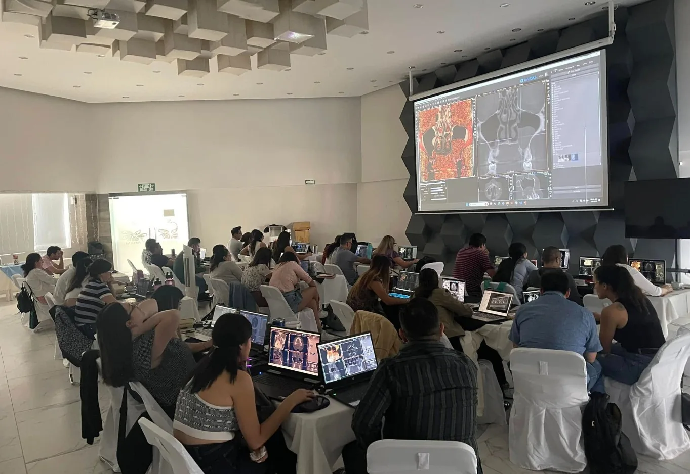Advanced CBCT course classroom with clinicians interpreting cases at individual workstations