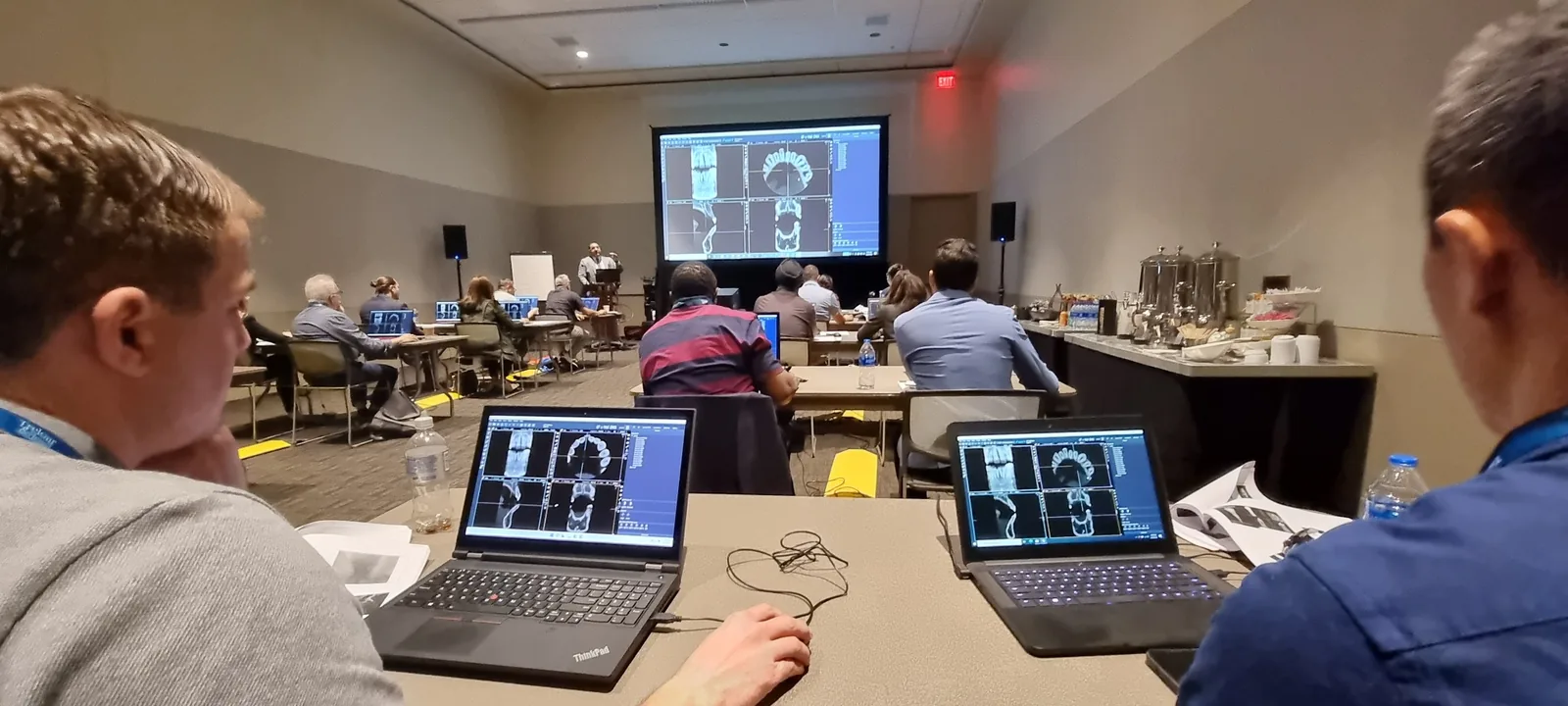 Dentists working hands-on with CBCT volumes during Dr. Bruno Azevedo's course